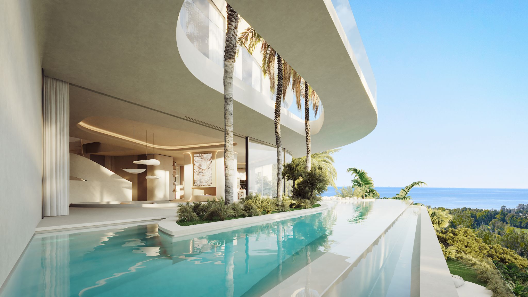 Modern villa with curved white balconies overlooking an infinity pool and palm trees, ocean in the distance.